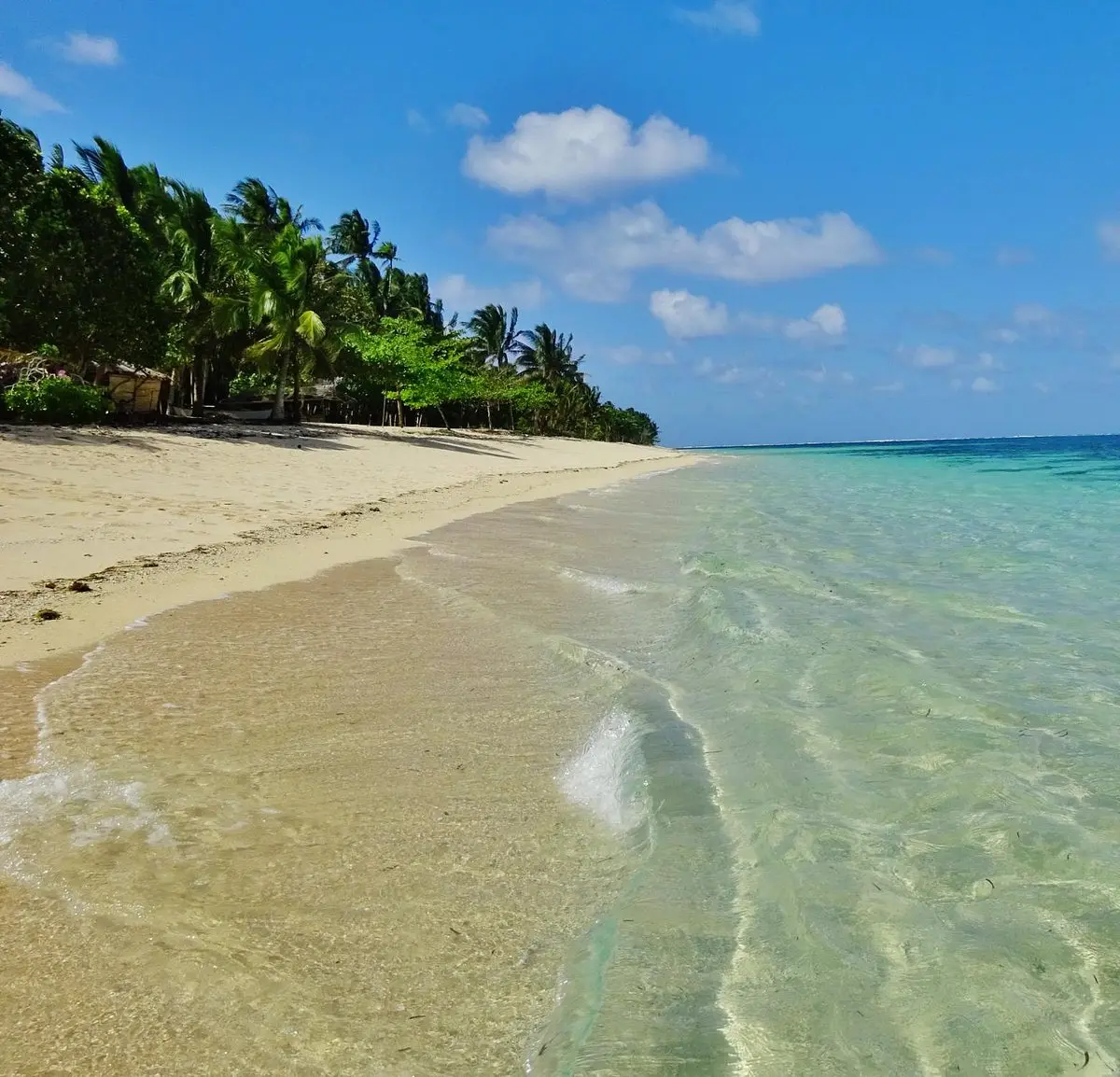 Soft white sand and crystal-clear water at Alegria Beach