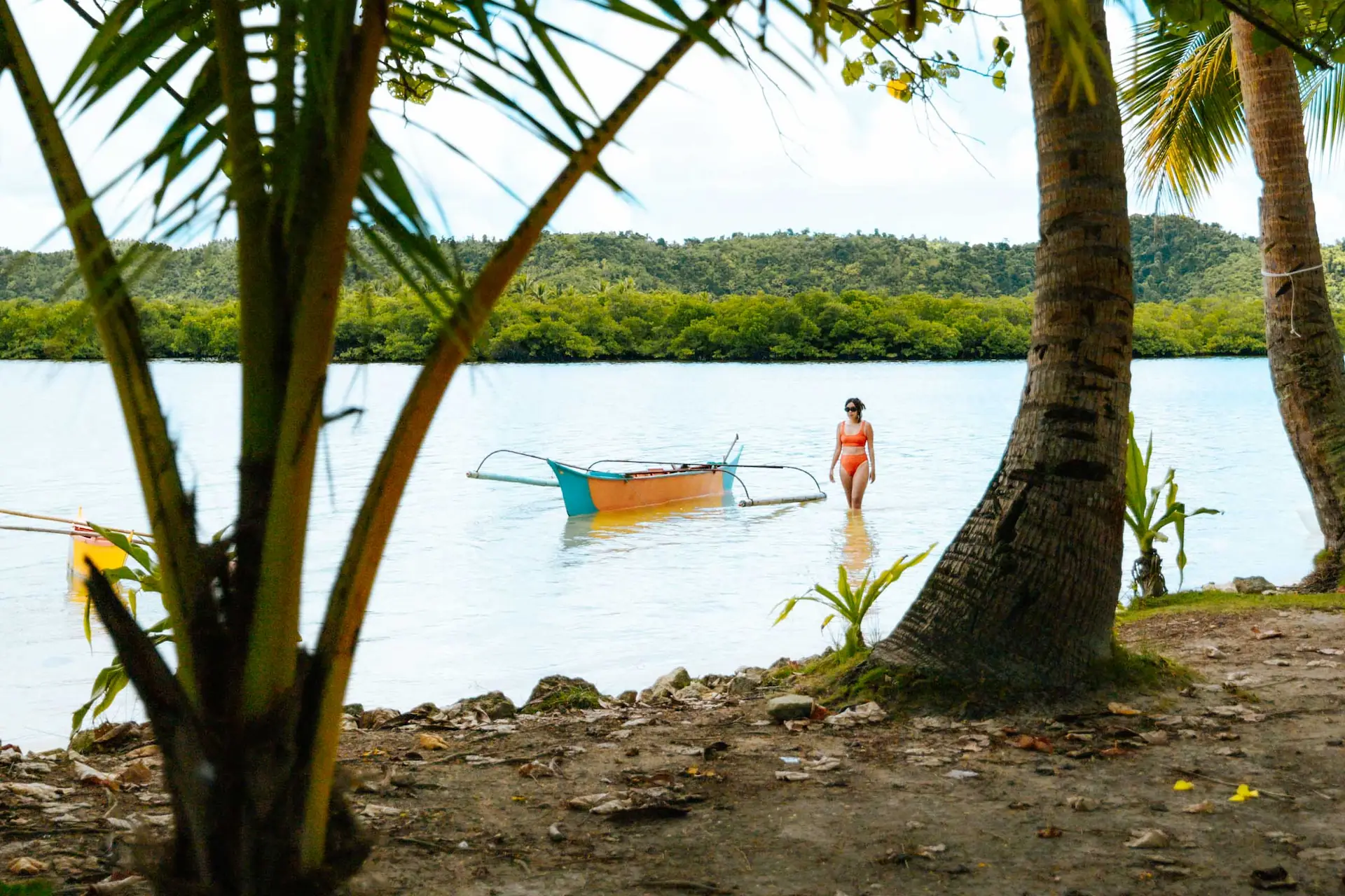 Secret Beach (Guiwan Beach) palm-fringed lagoon with turquoise water